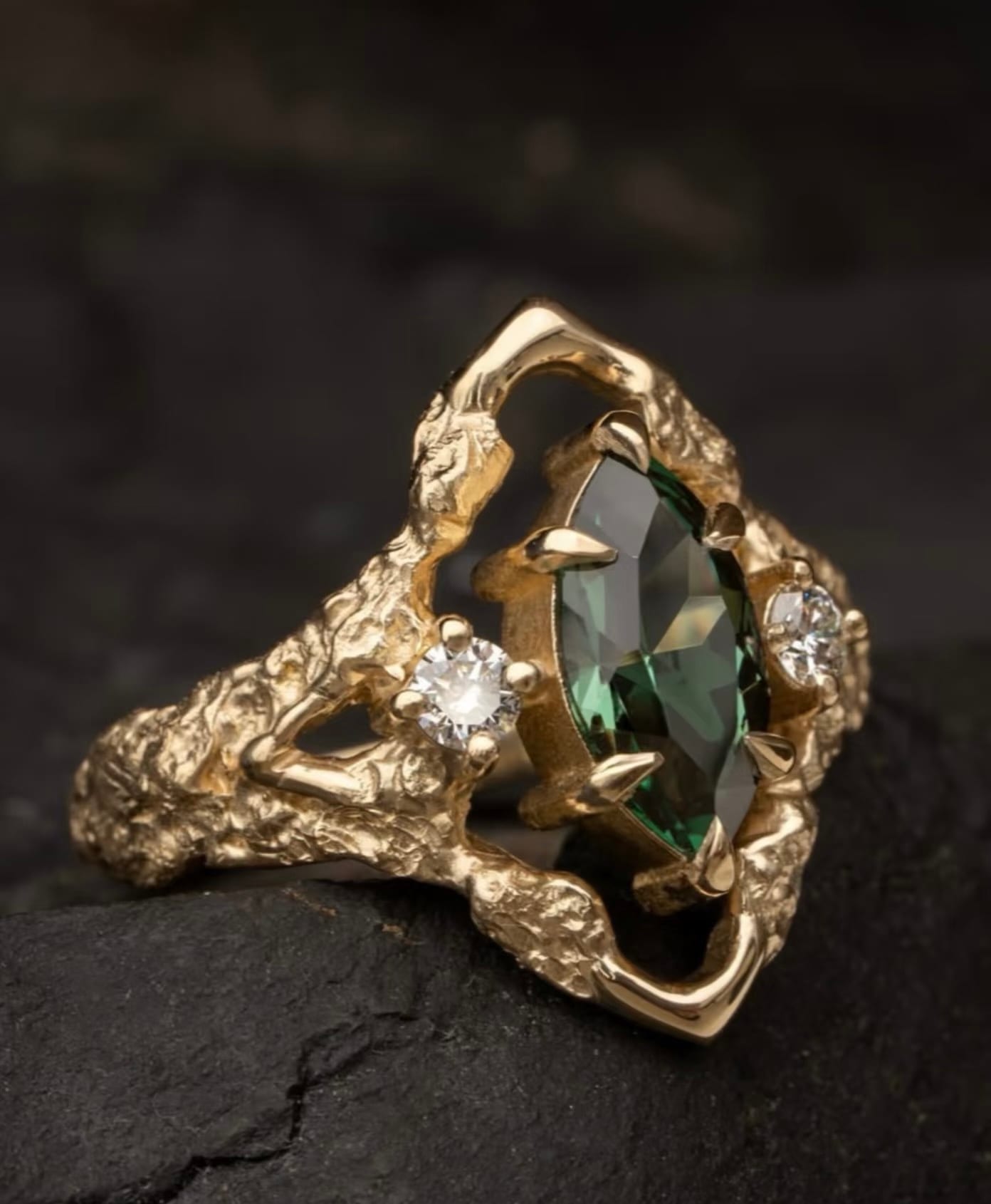 Green marquise stone ring with side diamonds in gold