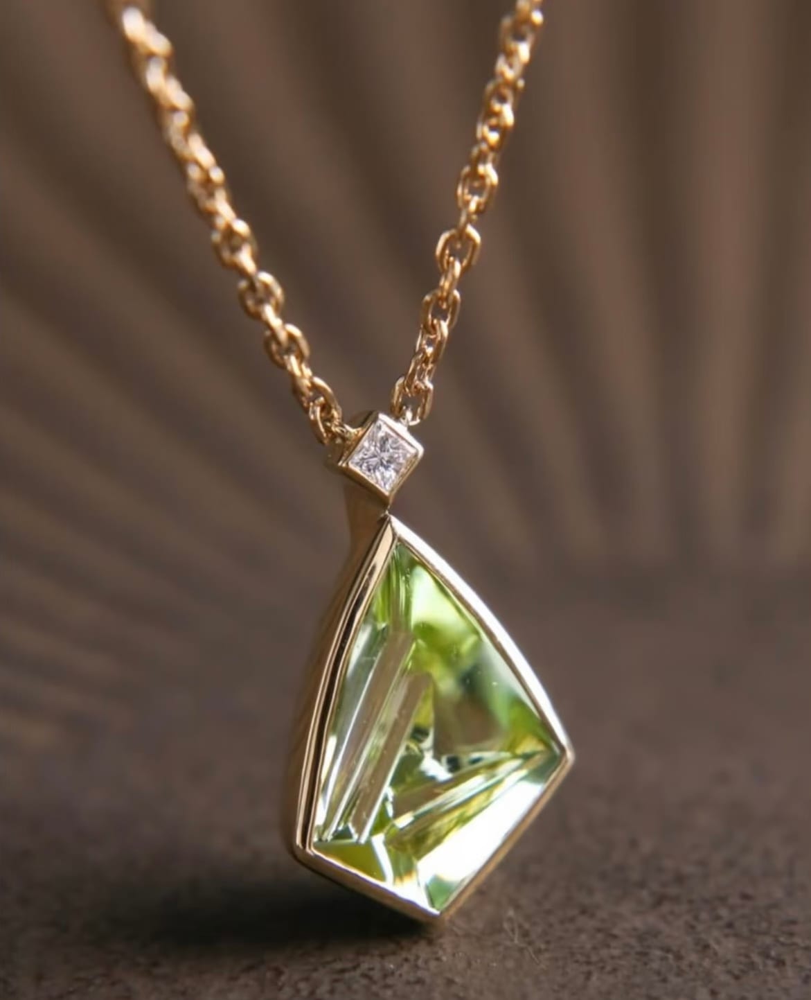 Green peridot pendant with a diamond bail on a gold chain