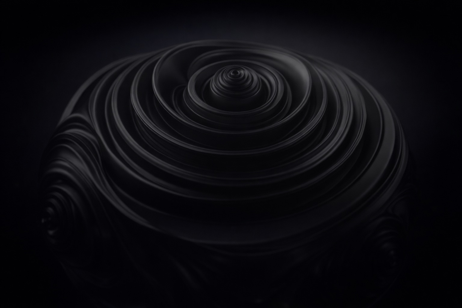 A material study from the studio: a dark sculpted form of concentric swirls
