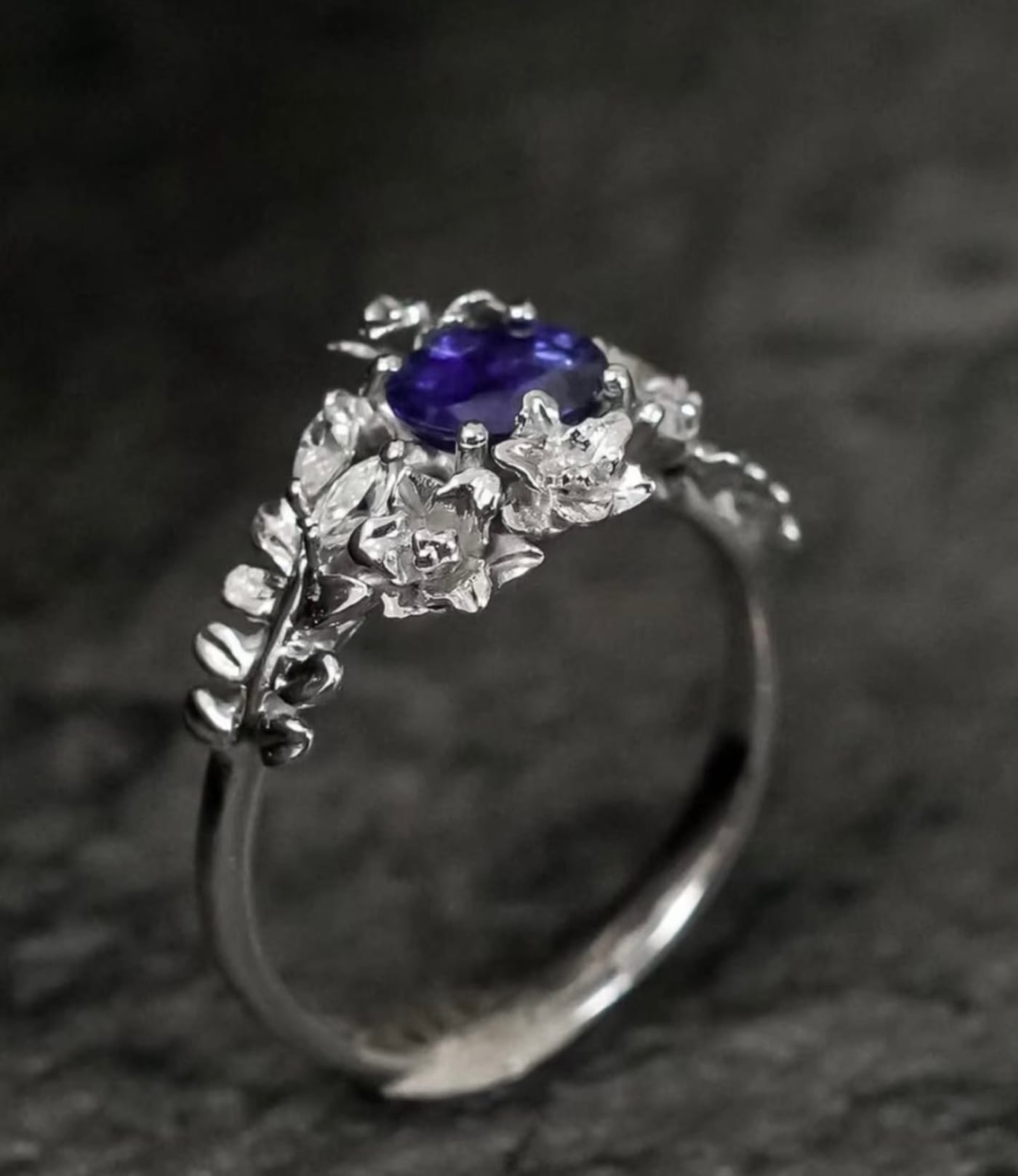 Violet stone ring in a white gold floral setting